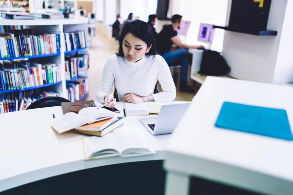 Asian Concentrated Serious Attentive Female Reading Book Pointing Pen While — Stock Photo, Image