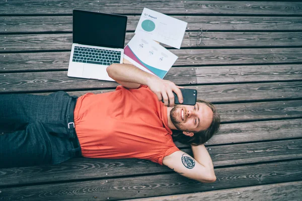 Young Content Bearded Man Casual Clothes Lying Back Park Relaxing — Stockfoto