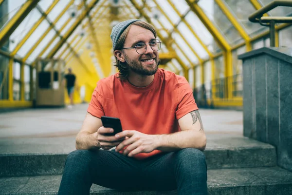 Young Happy Man Hat Glasses Smiling Looking Away Cellphone Hand — Stockfoto