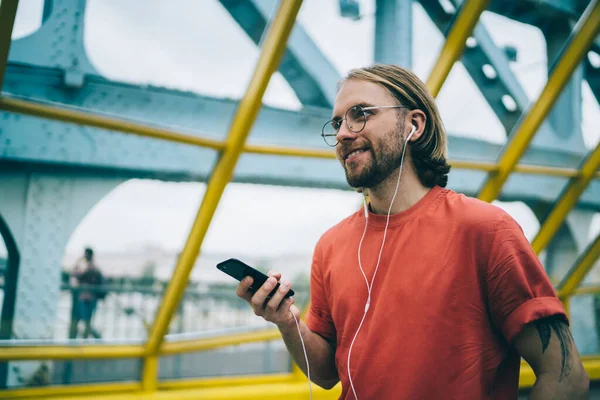 Smiling Guy Casual Clothes Glasses Earphones Listening Music Surfing Social — Stockfoto