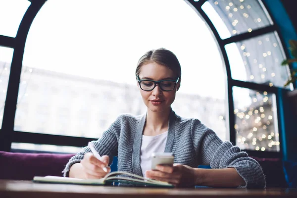 Calm Female Freelancer Casual Outfit Eyewear Sitting Table Taking Notes — Fotografia de Stock