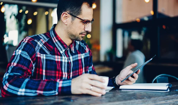 Jóképű Férfi Blogger Szemüvegben Teáscsészével Médiatartalommal Reggeli Órákban Kávézóban Generációs — Stock Fotó