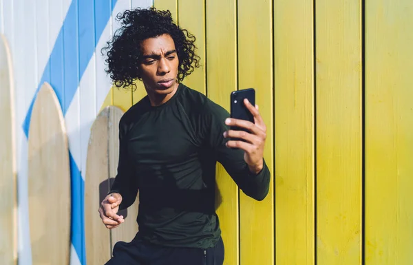 Pensive African American Male Curly Hair Tracksuit Surfing Internet Smartphone — Stock Photo, Image