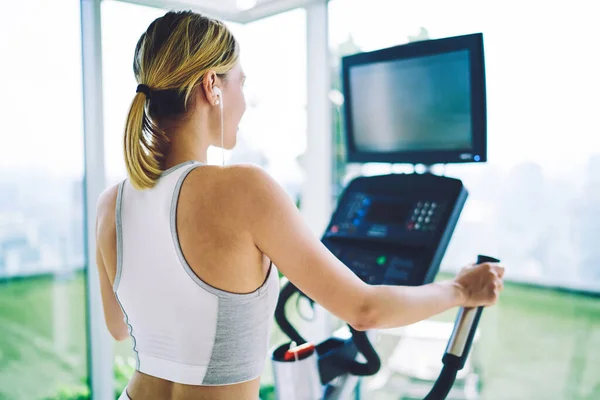 Back View Sporty Female Activewear Earphones Listening Music While Working — Fotografia de Stock