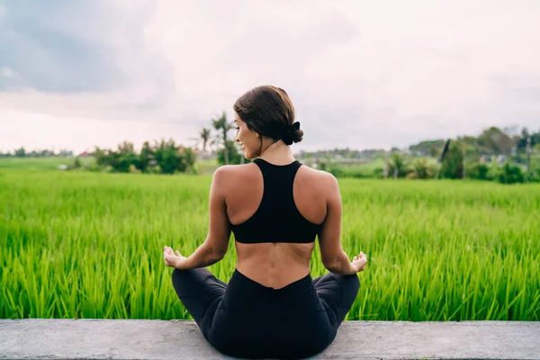 Back View Active Female Dressed Black Sportswear Sitting Lotus Pose — Stockfoto