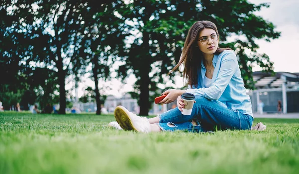 Contemplative Hipster Girl Takeaway Coffee Cup Smartphone Device Hands Thoughtful — Zdjęcie stockowe