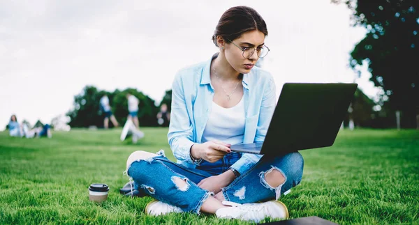 Skilled Female Student Using Wireless Connection Outdoors Watching Educational Webinar — стокове фото