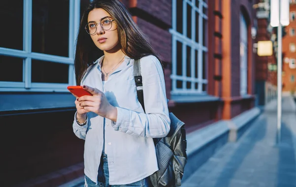 Pondering Female Tourist Optical Eyewear Vision Protection Holding Cellphone Technology — Zdjęcie stockowe