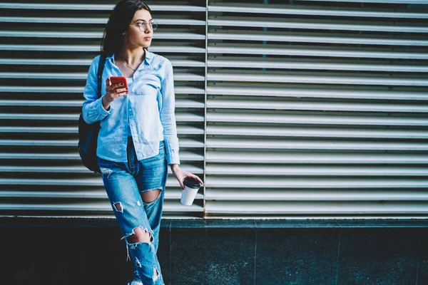 Contemplative Hipster Girl Classic Eyewear Holding Smartphone Coffee Cup Urban — Stockfoto