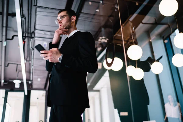 Pensive Businessman Wearing Black Formal Suit Browsing Mobile Phone Touching — Zdjęcie stockowe