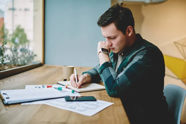 Side View Young Male Freelancer Taking Notes Notebook While Working —  Fotos de Stock