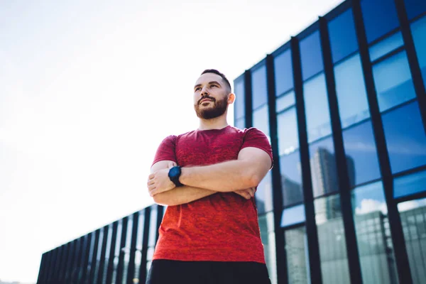 Bearded Male Sportswear Watch Looking Away Crossing Arms Standing Building — Stock Photo, Image