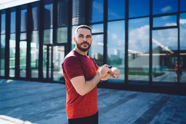 Thoughtful Bearded Guy Checking Heart Rate Smart Watch Looking Away — Zdjęcie stockowe