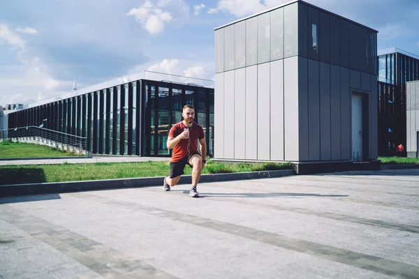 Full Body Modern Male Athlete Stretching Legs Phone Hand While — ストック写真