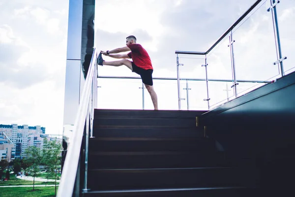 Side View Concentrated Sportsman Sneakers Standing Staircase Glass Railings Stretching — Stock Photo, Image