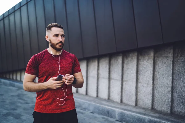 Side View Serious Male Athlete Wearing Sports Clothes Listening Song — Foto de Stock