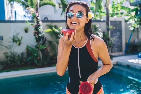 Charming Young Lady Toothy Smile Sunglasses Swimsuit Enjoying Fresh Pitaya — стоковое фото