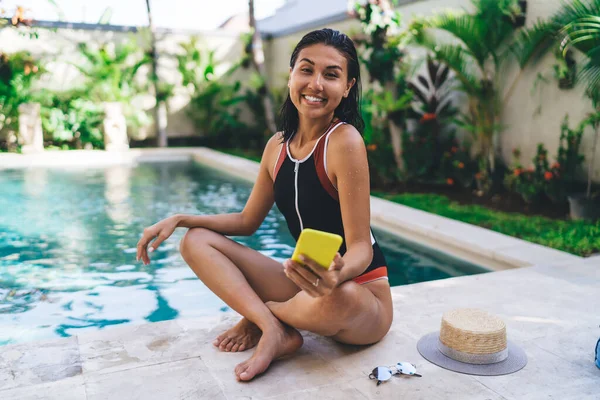 Smiling Ethnic Woman Swimwear Sitting Poolside Crossed Legs Looking Camera — Stockfoto