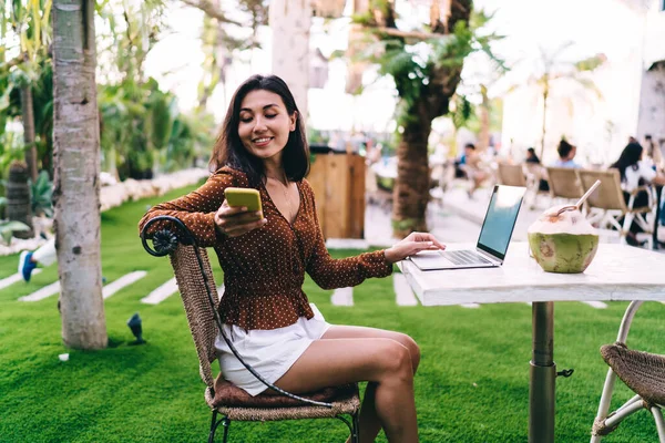 Happy Young Ethnic Female Casual Outfit Using Smartphone While Sitting —  Fotos de Stock