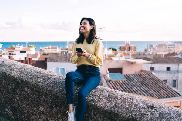 Cheerful Asian Brunette Female Casual Clothes Toothy Smile Sitting Stone — Stockfoto