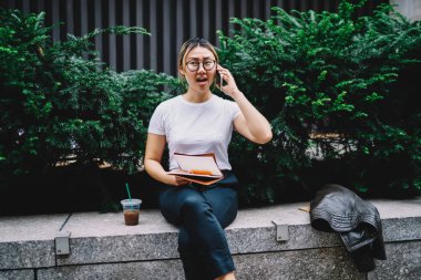 Akıllı telefon teknolojisiyle danışmanlık sırasında organizasyon sorunlarını çözen gözlüklü, kafası karışmış hippi kız. Mobil uygulama üzerinden eğitim kitabı okuyan ciddi Çinli öğrenci.