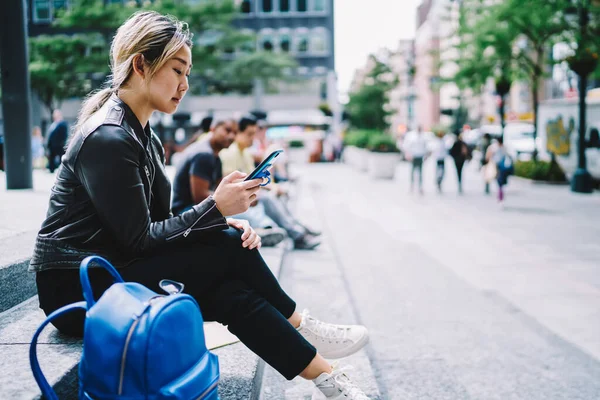 Chinese Hipster Girl Trendy Leather Jacket Using Cellphone Device Reading — ストック写真