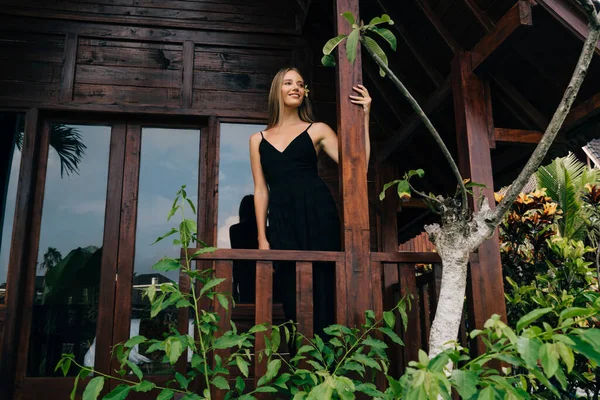 Happy Lady Stylish Dress Standing Veranda Looking Away While Chilling — Stockfoto