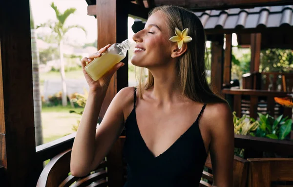 Side View Smiling Female Sipping Refreshing Drink While Sitting Balcony — 스톡 사진