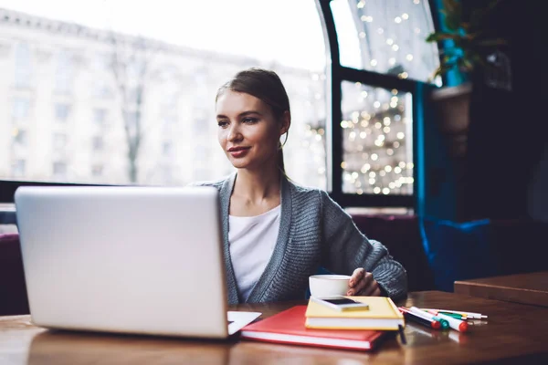 Dreamy Female Freelancer Casual Clothes Looking Away While Sitting Table — Stockfoto