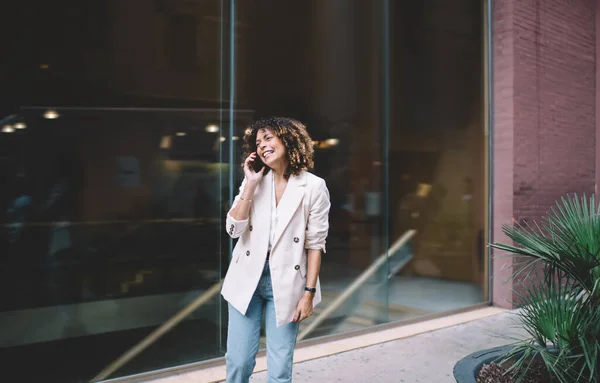 Happy Caucaisan female user connecting to 4g internet for making positive international conversation and mobile communication