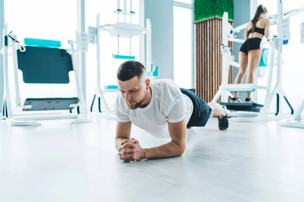 Serious Focused Strong Male Activewear Doing Plank Exercise Floor Bright — Stockfoto