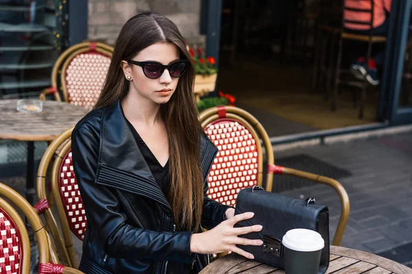 Confident Trendy Lady Black Leather Jacket Sunglasses Stylish Handbag Sitting — стоковое фото
