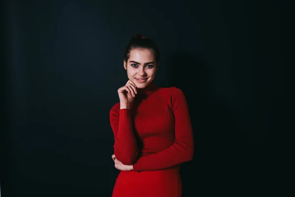 Young Attractive Female Model Red Clothes Hand Chin Looking Camera — Zdjęcie stockowe