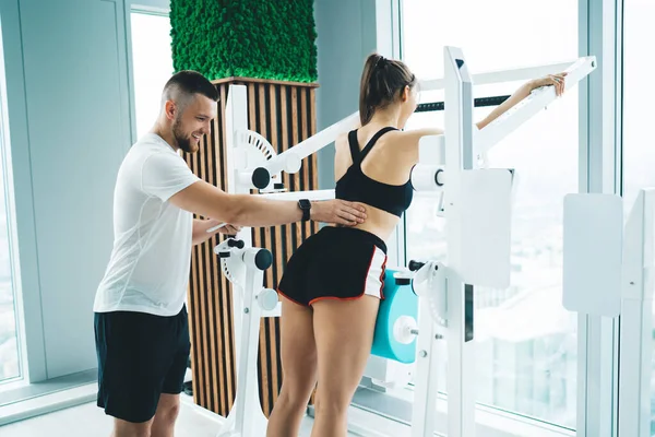 Young Glad Male Trainer Touching Back Anonymous Female Pupil Workout — Fotografia de Stock