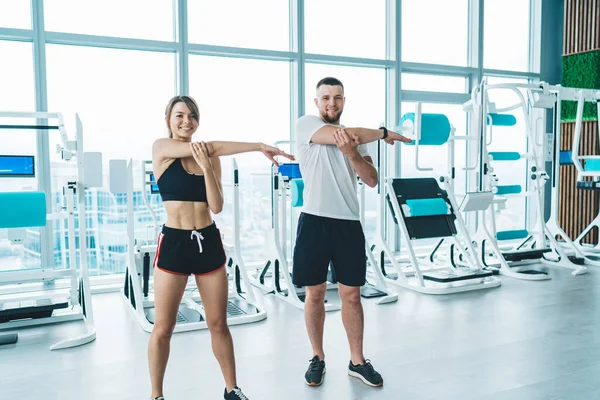 Cheerful Sportspeople Activewear Looking Camera While Stretching Arms Workout Modern — Fotografia de Stock