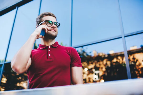 Smiling Young Man Polo Shirt Eyeglasses Having Conversation Smartphone Looking — Stockfoto