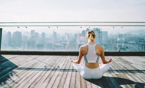 Back View Slim Female Sportswear Sitting Wooden Terrace Padmasana Pose — стокове фото