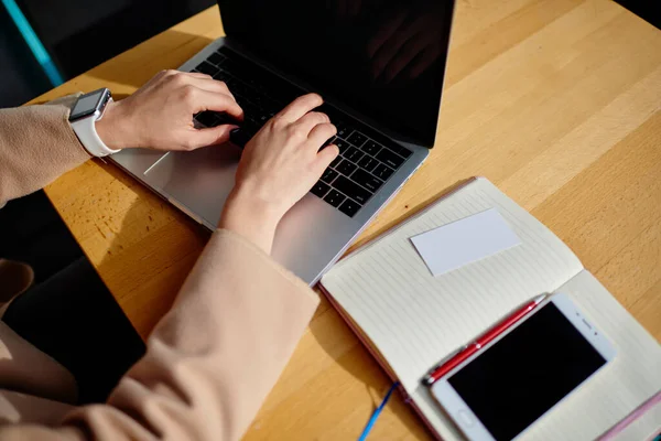 Crop Anonymous Woman Smart Watch Wrist Browsing Laptop While Sitting — стоковое фото
