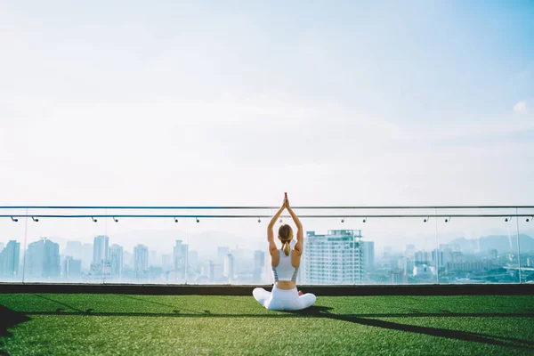 Back View Woman Doing Yoga Sukhasana Raising Hands Lawn Roof — Stockfoto