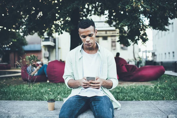 Young African American Man Casual Clothes Using Mobile Phone While — Zdjęcie stockowe