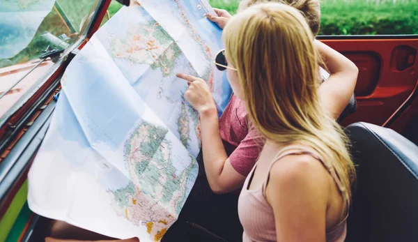 Unrecognizable Travelers Sitting Car Opened Paper Map Choosing Direction While — 图库照片