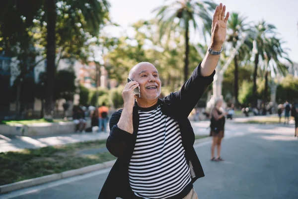 Happy Caucasian senior using roaming internet connection for international calling during solo vacations