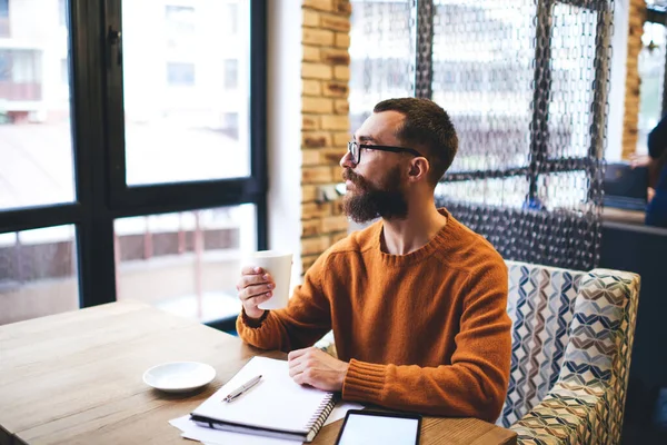 Bearded Male Freelancer Pensively Looking Out Window Drinking Tea While — Foto Stock