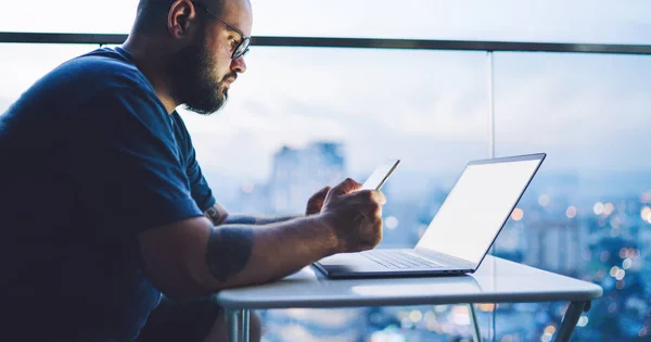 Side View Crop Bearded Male Sitting Table Window Laptop Mobile — Foto de Stock