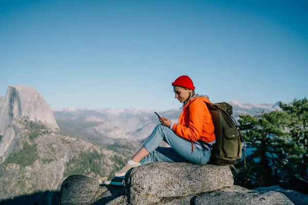 Side View Full Body Young Female Backpacker Using Phone While — Fotografia de Stock