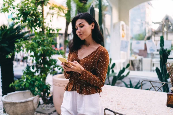 Calm Female Blogger Casual Wear Attentively Scrolling Social Media Cellphone — Zdjęcie stockowe