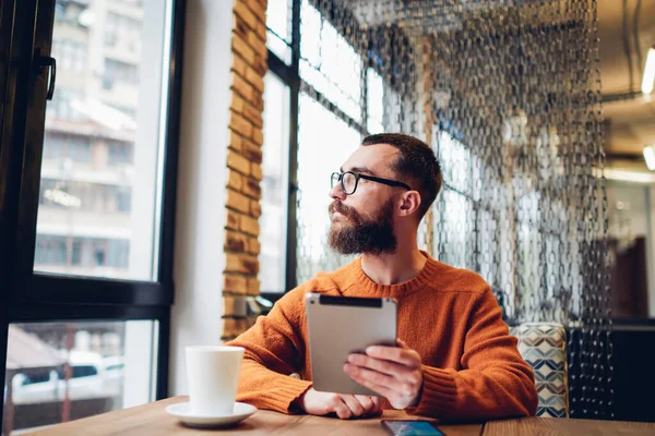 Serious Unshaven Male Casual Clothes Looking Away Sitting Wooden Table — Foto Stock