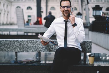  Platformun yanında demiryolu beklerken, mutlu erkek girişimci partnerini konuşmaya çağırıyor