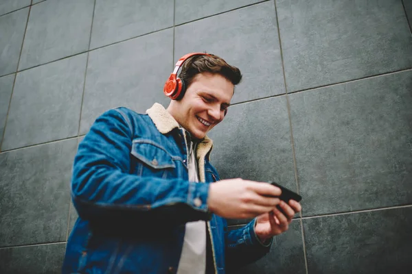 Cheerful Male Casual Outfit Toothy Smile Headphones Looking Screen Mobile — Stockfoto