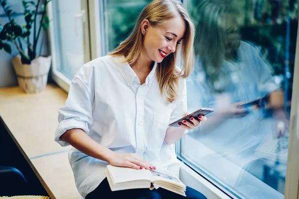 Smiling Young Female Casual White Blouse Sitting Window Looking Smartphone — 图库照片